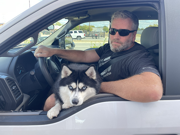 A man and his adorable pomeranian husky mix.